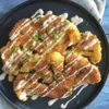 Crispy Herb-Crusted Cauliflower Steaks with Lemon-Caper Sauce on a platter