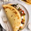 Savory Crepes with Goat Cheese & Roasted Veggies on a plate