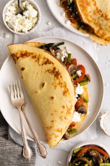 Savory Crepes with Goat Cheese & Roasted Veggies on a plate