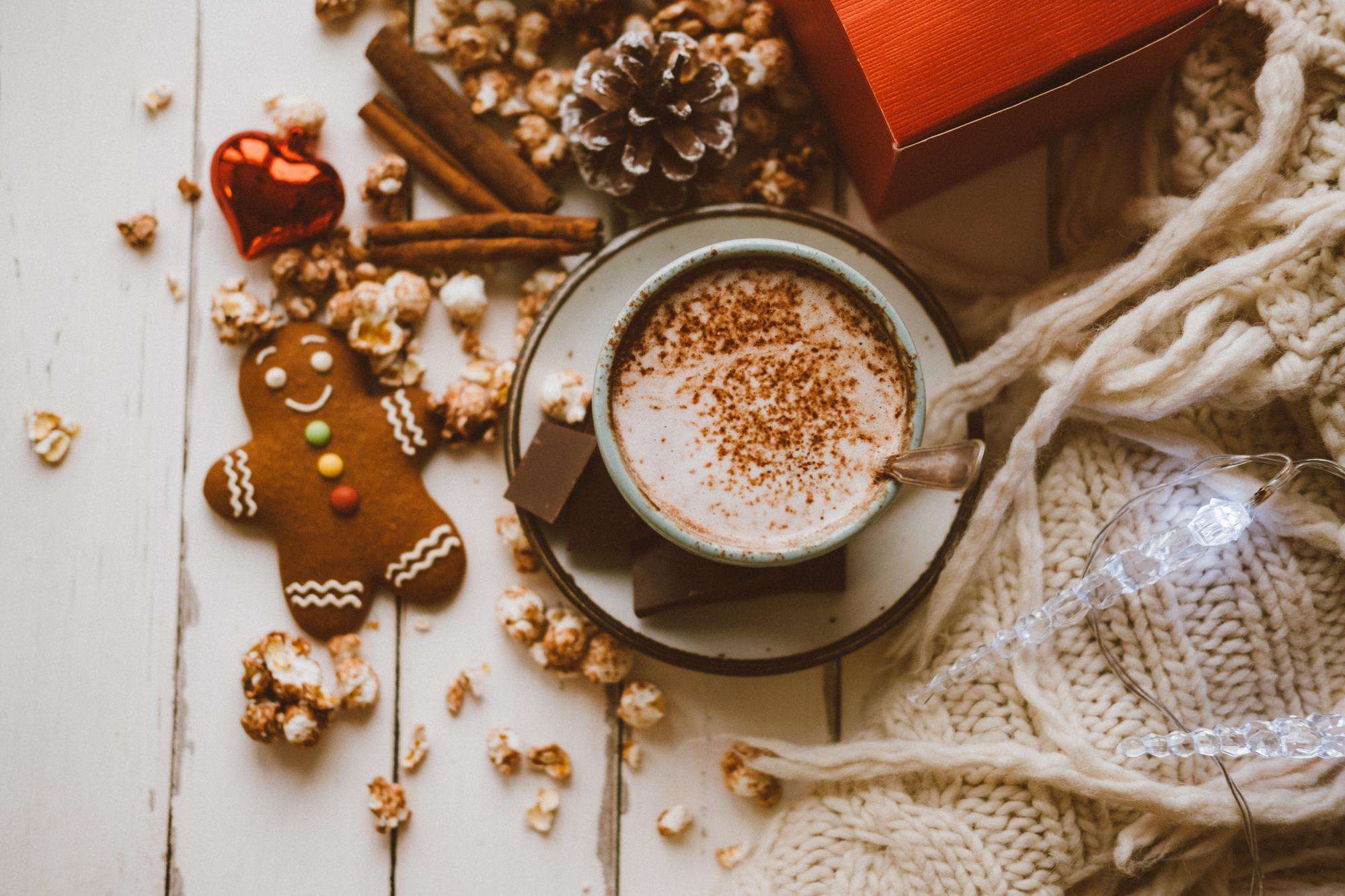 A mug of Gingerbread Hot Chocolate Surprise topped with whipped cream and a cinnamon stick