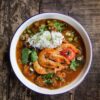 A steaming bowl of authentic Louisiana gumbo with shrimp, sausage, and okra