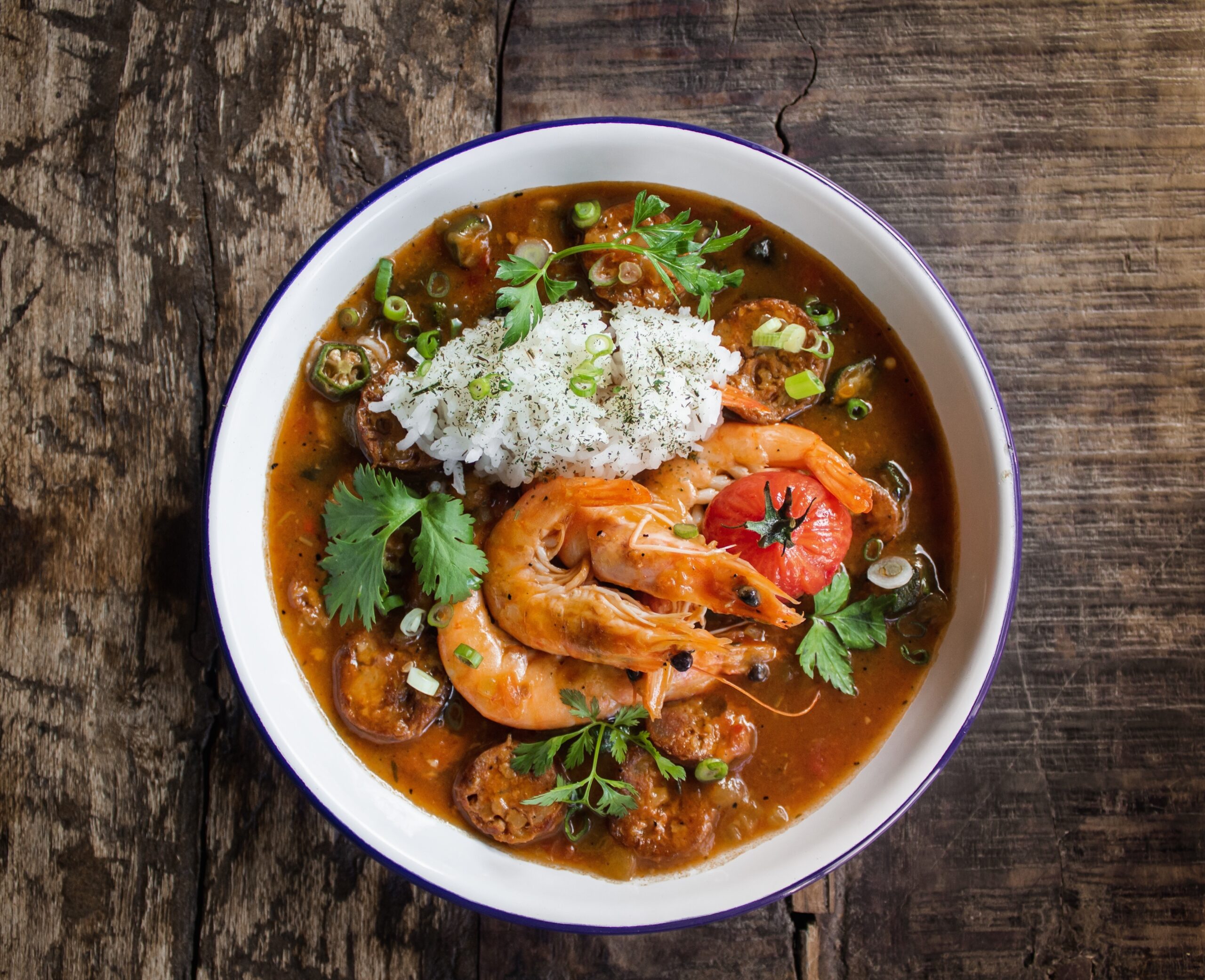 A steaming bowl of authentic Louisiana gumbo with shrimp, sausage, and okra