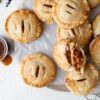 Salted Caramel Apple Hand Pies sprinkled with flaky salt on a board