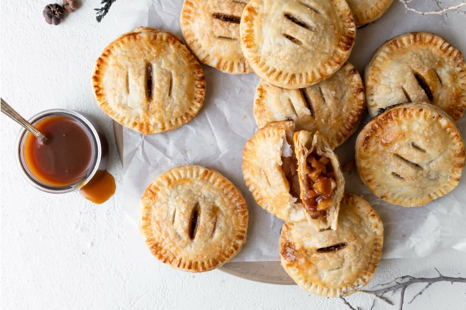 Salted Caramel Apple Hand Pies sprinkled with flaky salt on a board