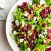 Cranberry Goat Cheese Arugula Salad in a white bowl