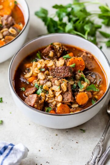 Hearty Beef & Barley Stew in a bowl, garnished with parsley, perfect for cold weather dinners.