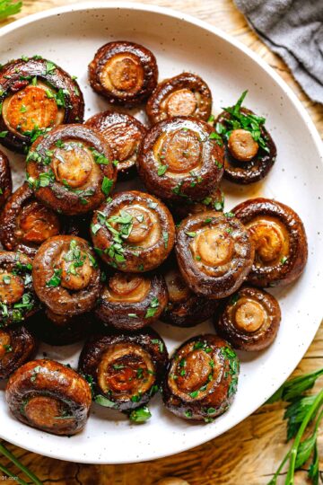 Garlic Butter Mushrooms served in a skillet, topped with fresh parsley.