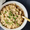 Creamy Truffle Risotto in a white bowl, garnished with Parmesan shavings and fresh herbs.