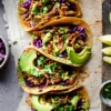 Vegan Jackfruit Tacos with vibrant toppings, fresh salsa, and crisp lettuce