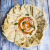 Mediterranean Hummus Recipe served with warm pita bread and garnished with olive oil and paprika