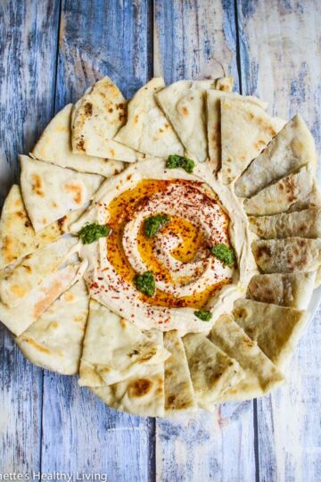 Mediterranean Hummus Recipe served with warm pita bread and garnished with olive oil and paprika