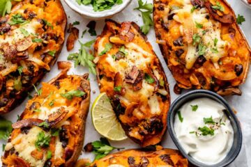 Loaded Potato Skins topped with melted cheddar, crispy bacon, green onions, and sour cream