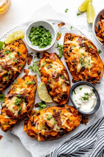 Loaded Potato Skins topped with melted cheddar, crispy bacon, green onions, and sour cream