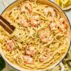 Shrimp Scampi with Linguine garnished with lemon wedges, parsley, and drizzled with garlic butter