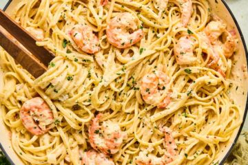 Shrimp Scampi with Linguine garnished with lemon wedges, parsley, and drizzled with garlic butter