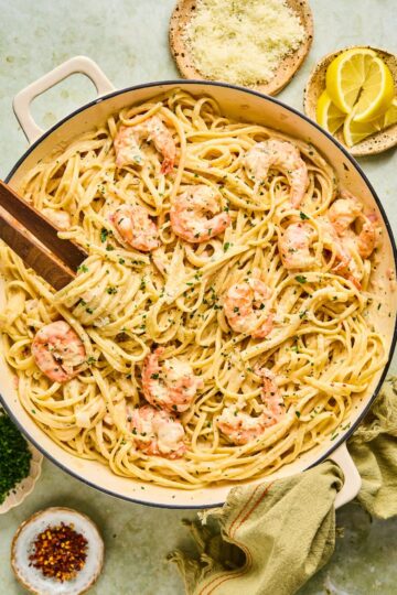 Shrimp Scampi with Linguine garnished with lemon wedges, parsley, and drizzled with garlic butter