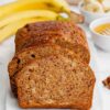 Gluten-Free Banana Bread with a golden crust, studded with walnuts, and a hint of banana slices