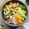 Vegan Poke Bowl with marinated tofu, sushi rice, edamame, avocado, cucumber, and a sesame-soy dressing