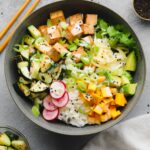 Vegan Poke Bowl with marinated tofu, sushi rice, edamame, avocado, cucumber, and a sesame-soy dressing