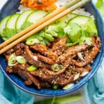 Spicy Korean Beef Bulgogi Bowls with rice and fresh vegetables