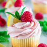 Raspberry Lemonade Cupcakes topped with airy Whipped Lemon Frosting