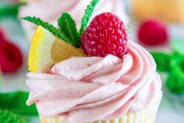 Raspberry Lemonade Cupcakes topped with airy Whipped Lemon Frosting